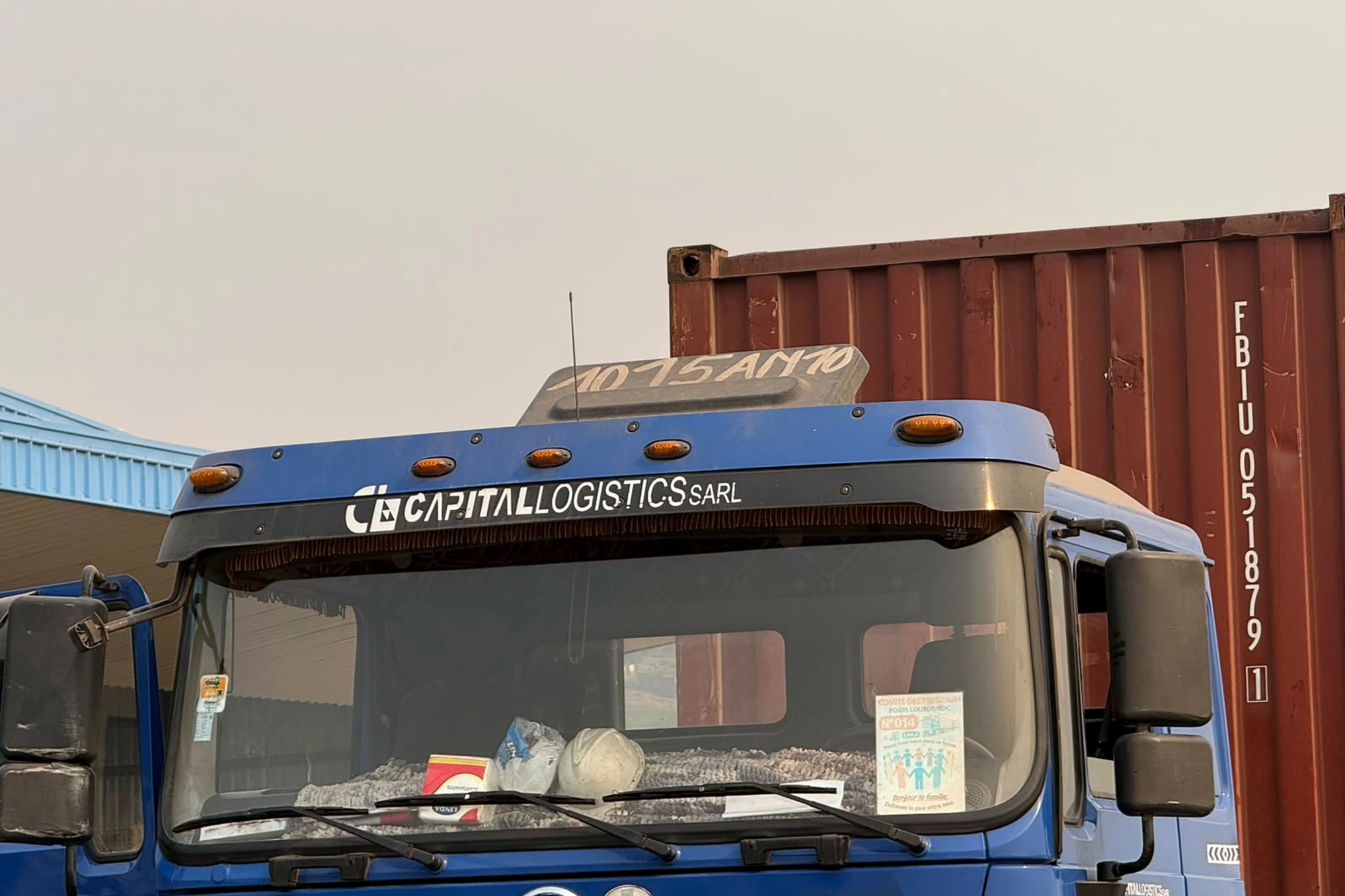 Capital Logistics SHACMAN truck cab with a shipping container at a DRC depot